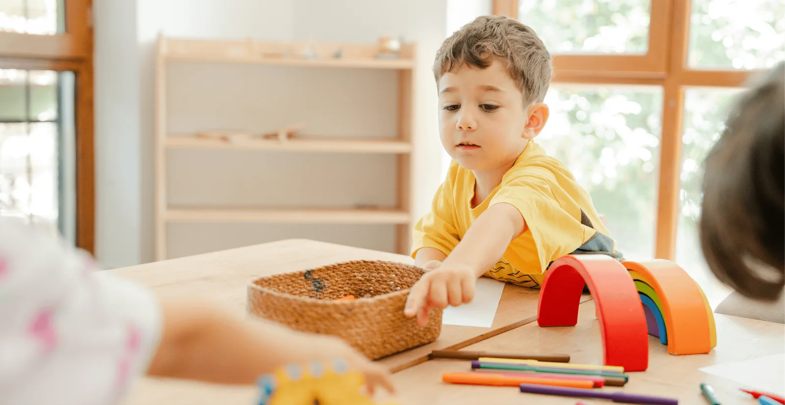 Two children working at a classroom table